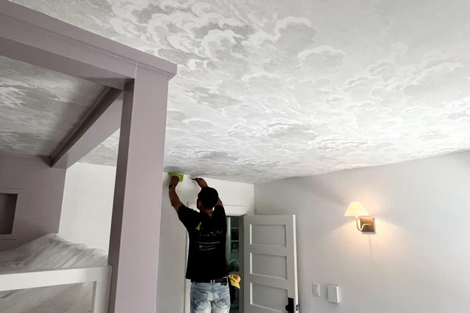 Professionals Installing Ceiling Wallpaper Using Specific Tools And Techniques To Ensure A Flawless Application