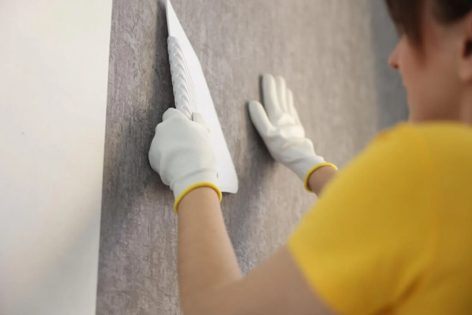 Woman Smoothing Stylish Gray Wallpaper Room Closeup 495423 72631