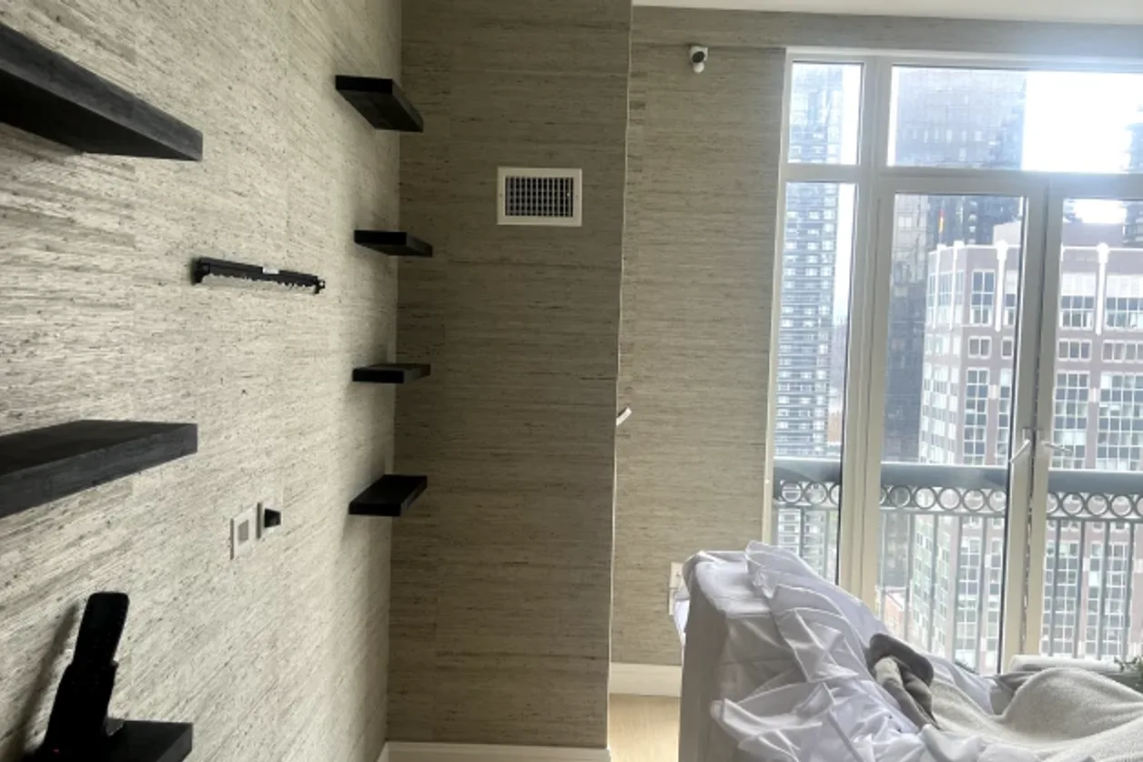 Textured grasscloth wallpaper installation in a living room by RCP Wallpaper