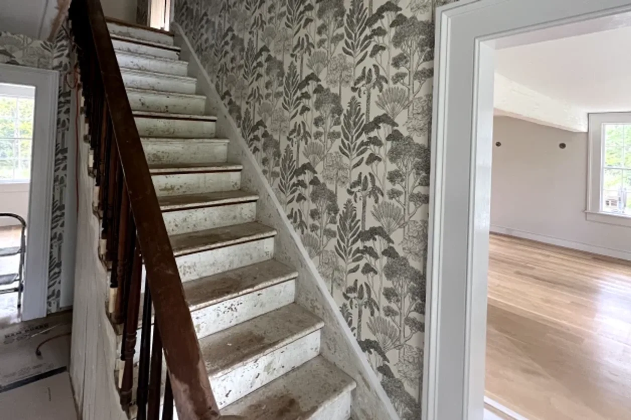 Two-story staircase wall wallpaper installation by RCP Wallpaper